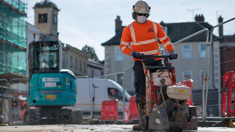 Worker outside working in hi vis and hard hat